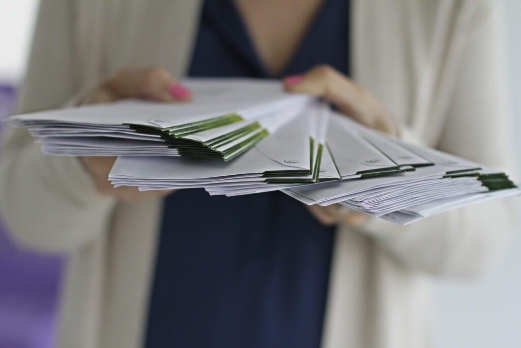 Woman holding stack of letters